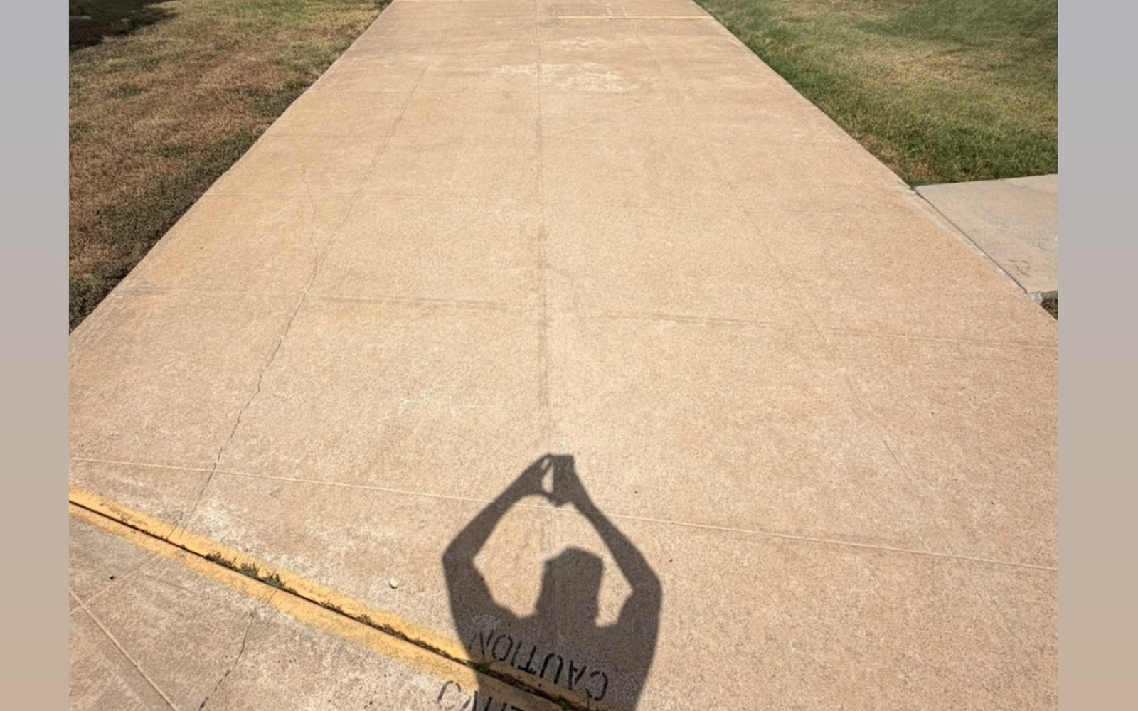 The same commercial walkway in the Austin TX area after pressure washing, showing bright even concrete